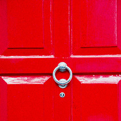 Image showing red handle in london antique brown door  rusty  brass nail and l