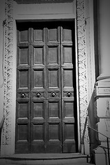 Image showing in london antique brown door  rusty  brass nail and light