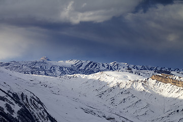 Image showing Winter mountains at evening and storm clouds