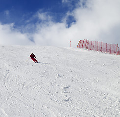 Image showing Skier on ski slope at nice sun day