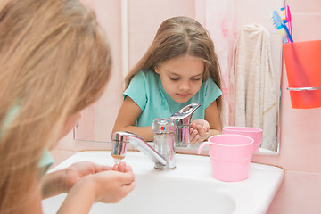 Image showing Six year old girl washes in the bathroom