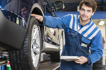 Image showing technician inspection a car 