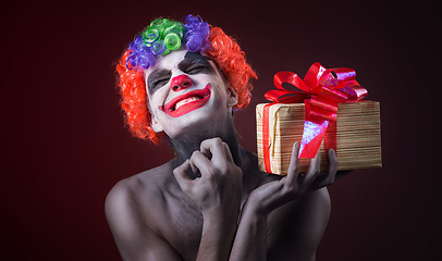 Image showing scary clown makeup and with a terrible gift