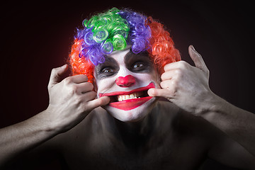 Image showing Evil Spooky Clown Portrait on dark background. expressive man