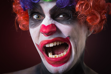 Image showing Evil Spooky Clown Portrait on dark background. expressive man