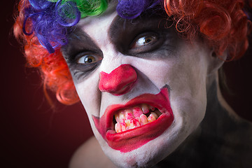 Image showing Evil Spooky Clown Portrait on dark background. expressive man