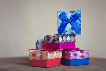 Image showing Gift box with red bow on wood background