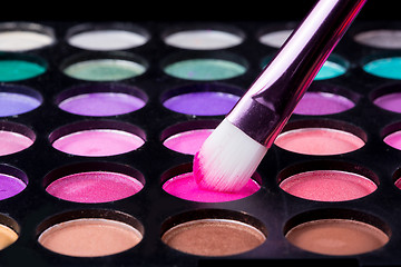 Image showing Colorful eye shadows palette with makeup brush.