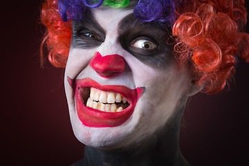 Image showing Evil Spooky Clown Portrait on dark background. expressive man