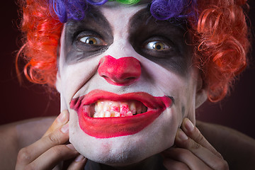 Image showing Evil Spooky Clown Portrait on dark background. expressive man