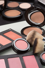 Image showing makeup cosmetics. compact powder, mineral foundation and makeup brushes