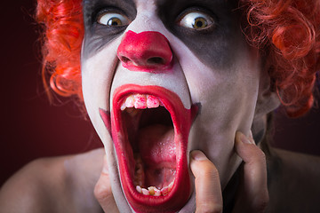 Image showing Evil Spooky Clown Portrait on dark background. expressive man
