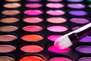 Image showing Colorful eye shadows palette with makeup brush.