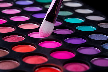 Image showing Colorful eye shadows palette with makeup brush.