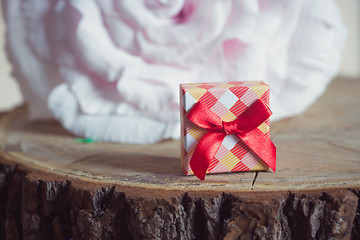 Image showing Gift box with red bow on wood background