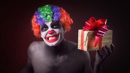 Image showing scary clown makeup and with a terrible gift