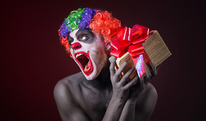 Image showing scary clown makeup and with a terrible gift