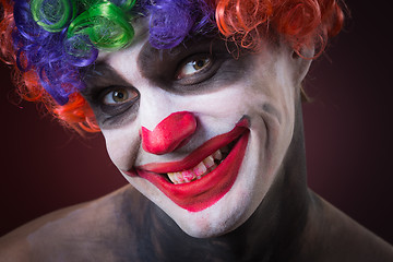 Image showing Evil Spooky Clown Portrait on dark background. expressive man