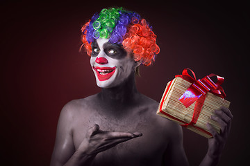 Image showing scary clown makeup and with a terrible gift