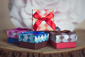 Image showing Gift box with red bow on wood background