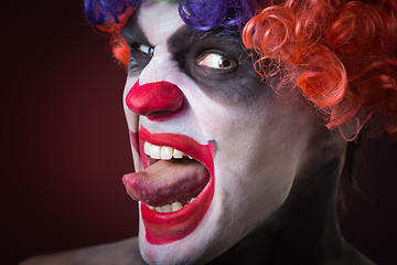 Image showing Evil Spooky Clown Portrait on dark background. expressive man