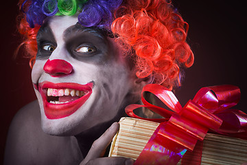 Image showing scary clown makeup and with a terrible gift