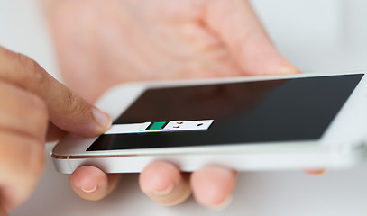 Image showing close up of woman with smartphone doing blood test