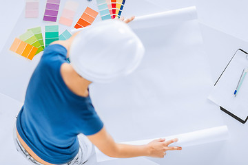 Image showing woman with color samples and blueprint