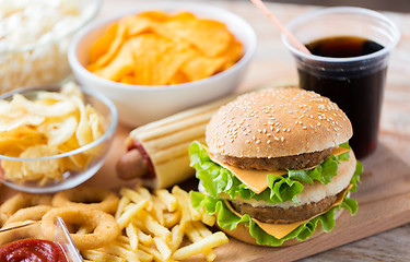 Image showing close up of fast food snacks and drink on table