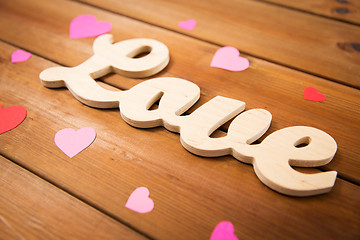 Image showing close up of word love with red paper hearts