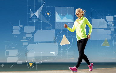 Image showing smiling young woman walking outdoors