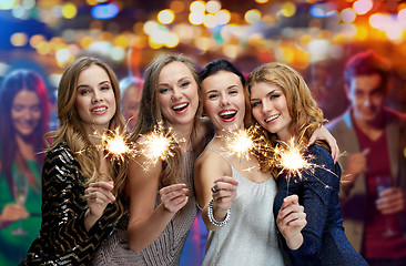 Image showing happy young women with sparklers at night club