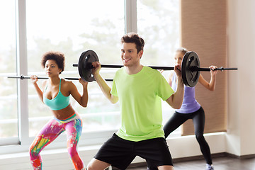 Image showing group of people exercising with barbell in gym