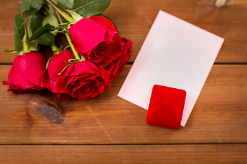 Image showing close up of gift box, red roses and greeting card