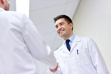 Image showing smiling doctors at hospital doing handshake