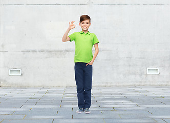 Image showing happy boy in white t-shirt showing ok hand sign