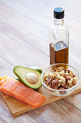 Image showing close up of food and olive oil bottle on table