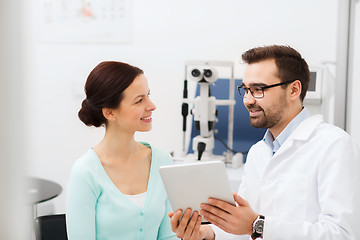 Image showing optician with tablet pc and patient at eye clinic