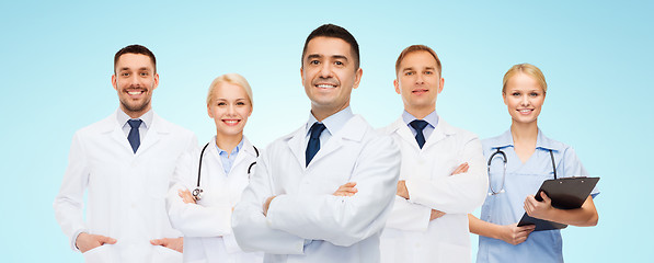 Image showing group of smiling doctors with clipboard