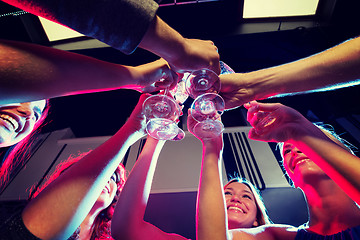 Image showing smiling friends with glasses of champagne in club