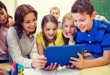 Image showing group of kids with teacher and tablet pc at school