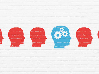 Image showing Learning concept: head with gears icon on wall background