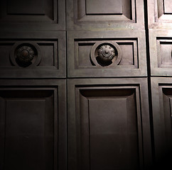 Image showing in london antique brown door  rusty  brass nail and light