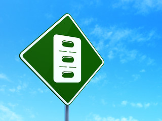 Image showing Health concept: Pills Blister on road sign background