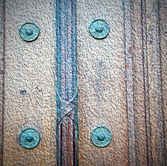 Image showing in london antique brown door  rusty  brass nail and light