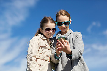 Image showing happy girls with smartphone taking selfie outdoors