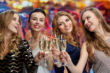 Image showing happy women with champagne glasses over lights