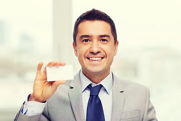 Image showing smiling businessman in suit showing visiting card