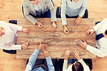 Image showing close up of business team sitting at table