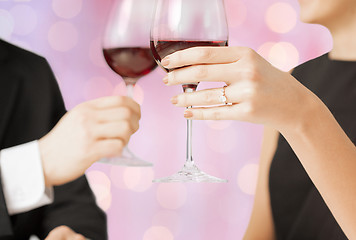 Image showing happy engaged couple clinking wine glasses